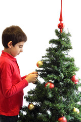 Young boy decorating a Christmas tree