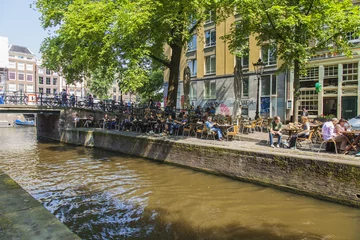 Fotobehang Amsterdam, Netherlands. Summer cafe on the city street © Elena Belyaeva