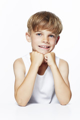 Portrait of young boy in vest, studio.