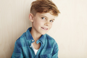 Portrait of young boy in checked shirt.
