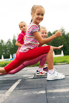 Children training on stadium stretching