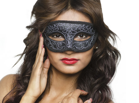 Beautiful young woman wearing Venetian mask