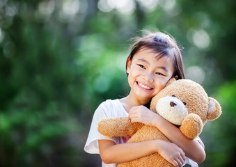 Asia little girl with doll bear