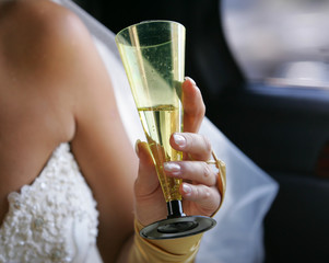 hand of a bride with a glass of champagne