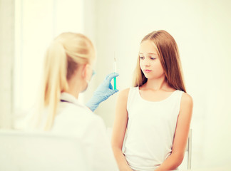 doctor doing vaccine to child in hospital