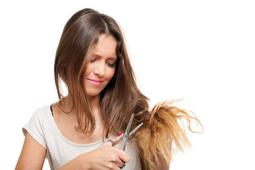 Young woman looking at split ends