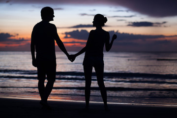 two romantic young people in love at sunset