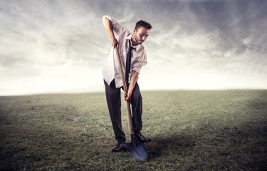young man digging in a field