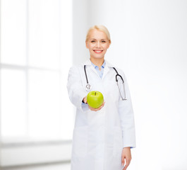 smiling female doctor with green apple