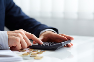 Men's hands with calculator