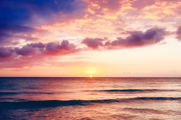 Naklejka na ściany i meble Beautiful sunset above the sea.