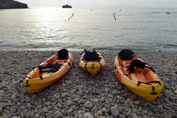 Yellow kayaks on the summer beach in Spain