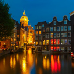 Fototapeta premium Night city view of Amsterdam canal, church and bridge