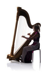 Silhouette of woman with harp
