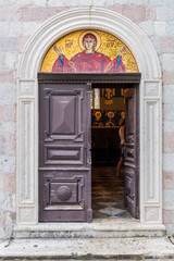 Fototapeta na wymiar Mosaic orthodox icon above the door in Montenegro