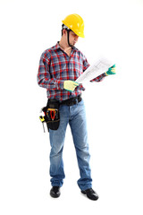 Male construction worker examining blueprint