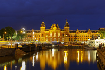 Night city view of Amsterdam canal and Centraal Station