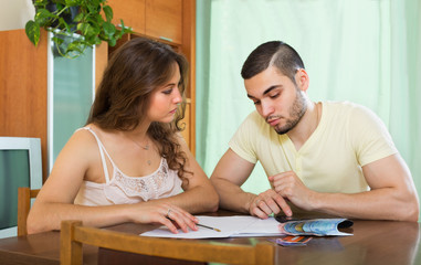 Fototapeta premium Couple with money and documents