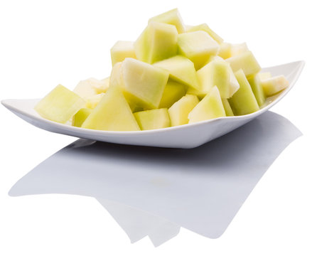 Bite Sized Honeydew Pieces On White Plate