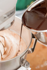 Fototapeta na wymiar Mixxing flour, eggs, sugar and hot chocolate in mixxing machine