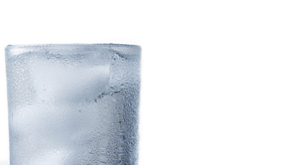 Glass with water and ice white background