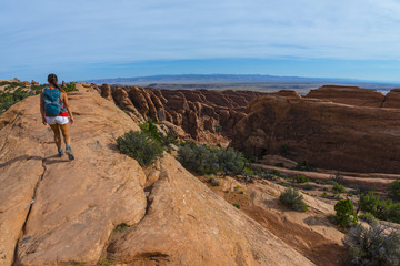 Female hiker on a Devils Garden trail to Double O Arch