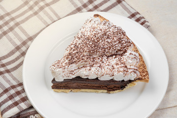 Chocolate Tart with cream and cocoa powder on the top