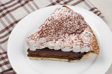 Chocolate Tart with cream and cocoa powder on the top