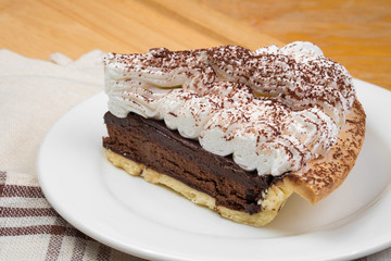 Chocolate Tart with cream and cocoa powder on the top