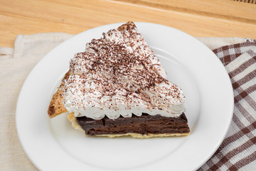 Chocolate Tart with cream and cocoa powder on the top