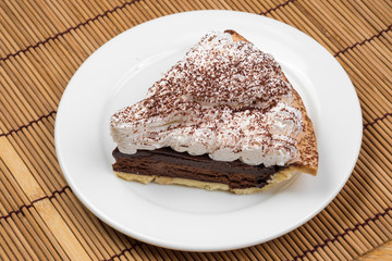 Chocolate Tart with cream and cocoa powder on the top