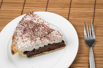 Chocolate Tart with cream and cocoa powder on the top