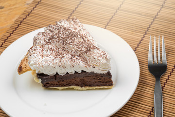 Chocolate Tart with cream and cocoa powder on the top