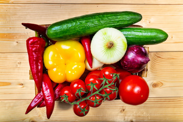 Close up of various colorful raw vegetables in a basket