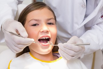 Pediatric dentist examining a patients teeth