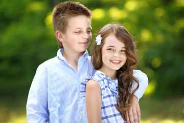Fototapeta premium Portrait of a boy girl in a summer