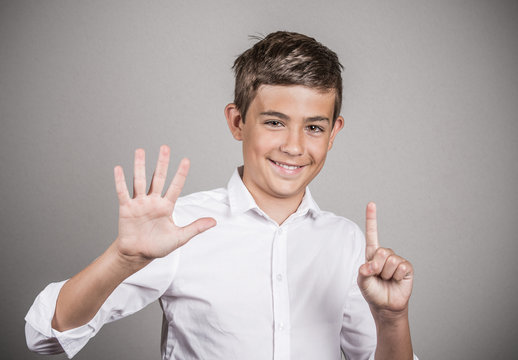 Handsome teenager showing 6 fingers, palm, number six gesture