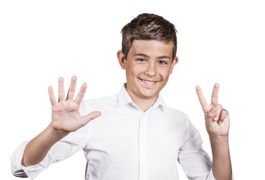 Happy teenager showing seven fingers, number 7 gesture