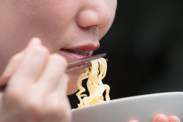woman eating noodle