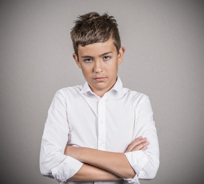 Skeptical annoyed teenager boy isolated on grey background 