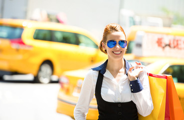 Happy, young  shopping woman in Manhattan NYC