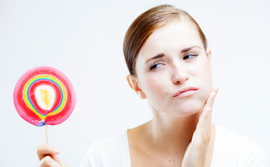 Woman having toothache after eating sweets