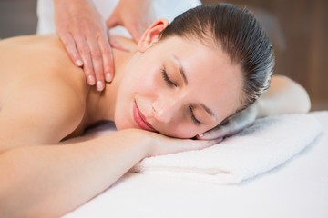 Obraz na płótnie Canvas Attractive woman receiving back massage at spa center