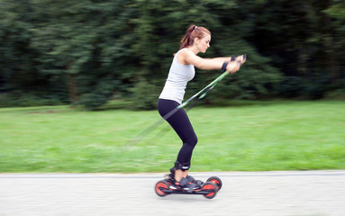 Woman cross-country skiing with roller ski