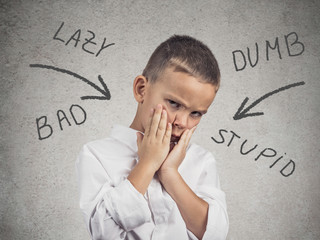 Boy bullied at school, home, isolated grey wall background 