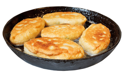 few patties in frying pan isolated on white
