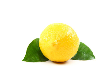 Fresh lemon with green leaves.