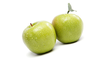 Green apples in drops of water.