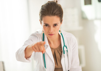 Doctor woman pointing in camera