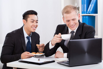 Two businessmen eating lunch